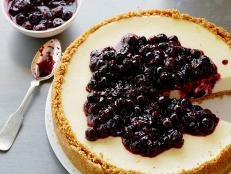 Bake Tyler Florence's Ultimate Cheesecake recipe from Food Network for a zesty-sweet classic topped with warm lemon blueberries.