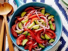 For a fresh salad standby, try Rachael Ray's Tomato, Onion and Cucumber Salad recipe from 30 Minute Meals on Food Network.
