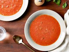 Serve Ina Garten's Roasted Tomato Basil Soup recipe, made with canned and fresh plum tomatoes, for an elegant starter from Barefoot Contessa on Food Network.