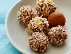 Roll Alton Brown's melt-in-your-mouth Chocolate Truffles from Food Network for a luxurious treat that works as a perfect gift.