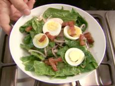 To make his Spinach Salad with Warm Bacon Dressing recipe from Good Eats on Food Network even better, Alton Brown tops it with sliced eggs and mushrooms.
