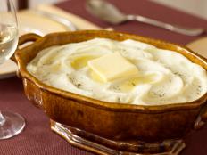 Tyler Florence's Mashed Potatoes recipe from Food Network is foolproof: Butter and cream guarantee richness, while the bay leaf and chives add herbal notes.