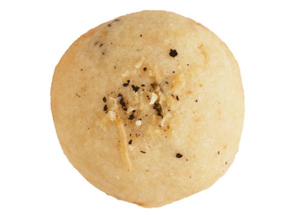 A cookie sprinkled with parmesan and black pepper 