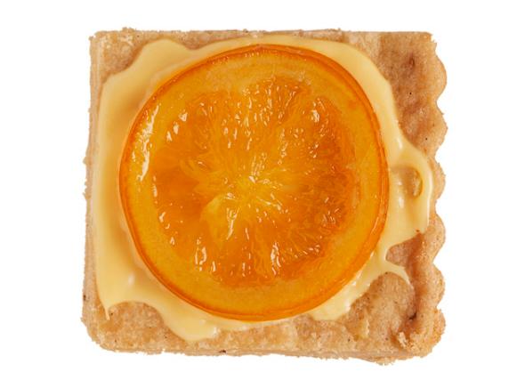 Slice of Citrus Fruit on a Piece of Walnut Lavendar Shortbread against a White Background