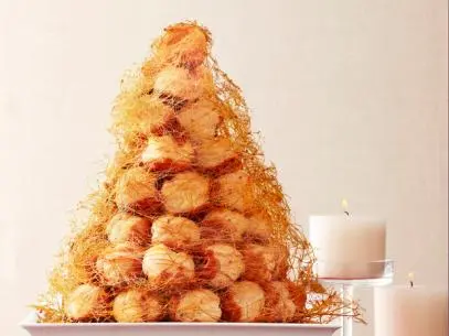 Croque en Bouche on a White Plate Placed Near two white candles