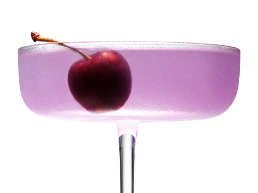 A light Purple Cocktail with a Cherry in it
