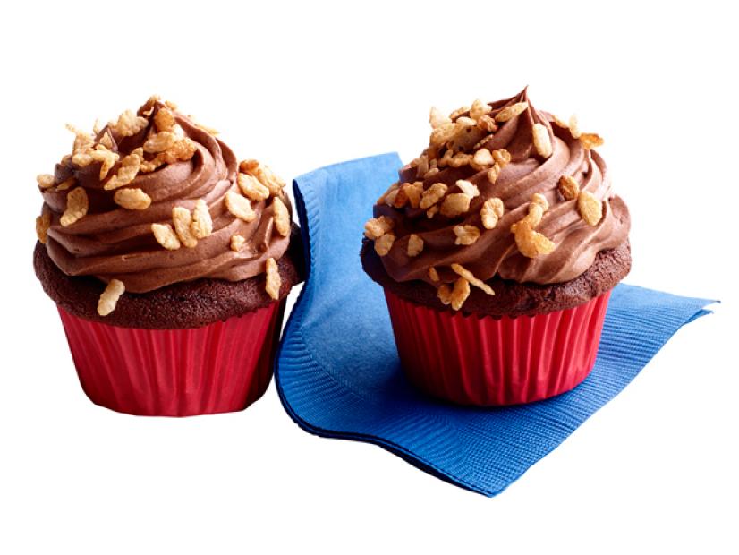 Mini chocolate cupcakes in red cupcake wrappers with chocolate toppings and Rice Krispies
