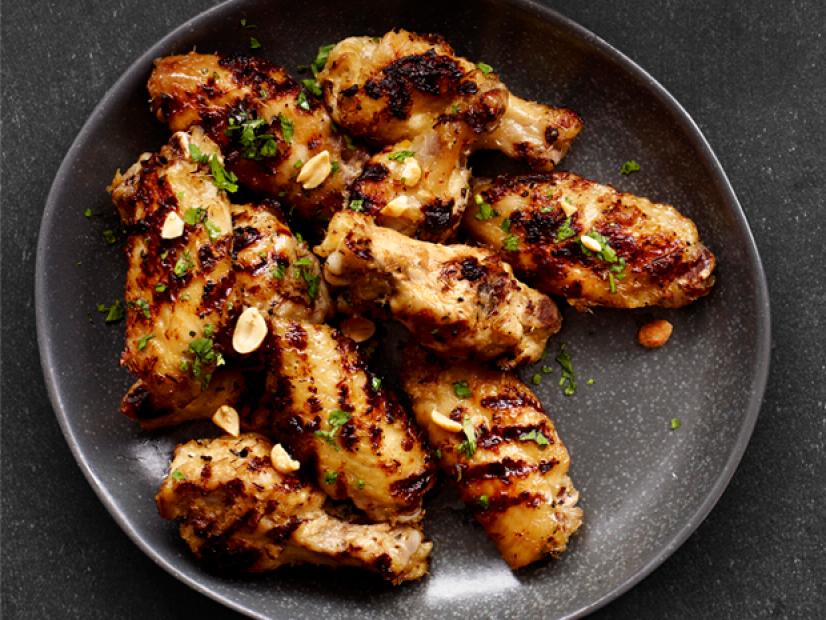 Grilled Chicken wings sprinkled with herbs on a charcoal gray plate