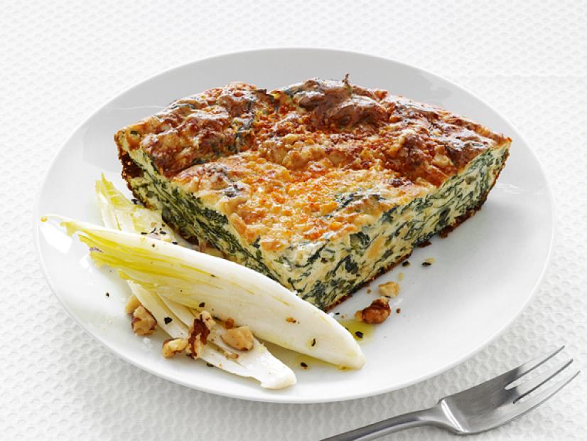 A slice of quiche on a small white plate