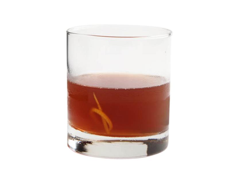 A dark brown drink in a short glass