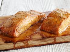 Cooking salmon over indirect heat on the grill brings smoky flavor to Bobby Flay's recipe for Cedar Plank Salmon from BBQ with Bobby Flay on Food Network.