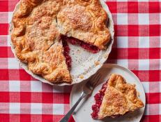 Bake an all-American Cherry Pie recipe from Food Network using fresh or frozen cherries and a buttery pie dough crust for a fruity summer dessert.