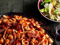Dish of Orecchiette with Meatballs Beside a Salad in a Dish 