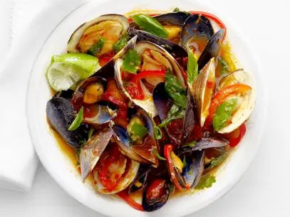 Clams and Mussels in Thai Curry with Red Bell Peppers and Lime in A White Bowl