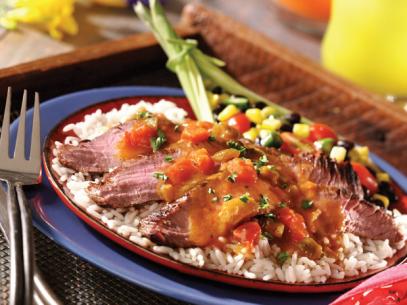 Flank Steak topped with salsa on a bed of white rice