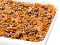Top Ellie Krieger's Sweet Potato-Pecan Casserole recipe from Food Network Magazine with brown sugar and chopped pecans for Thanksgiving or as an any-day side.