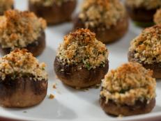 For an elegant appetizer that takes only 35 minutes to make, try Giada De Laurentiis' Stuffed Mushrooms recipe from Everyday Italian on Food Network. These vegetarian bites are stuffed with breadcrumbs, Pecorino Romano, garlic, parsley and mint then baked until crispy on top.