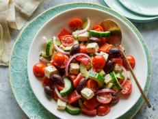 Try Ina Garten's fresh Greek Salad recipe from Barefoot Contessa on Food Network for a colorful veggie dish that's studded with salty olives and feta cheese.