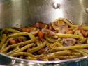 Bacon braised string beans are cooked with mushrooms and bacon.