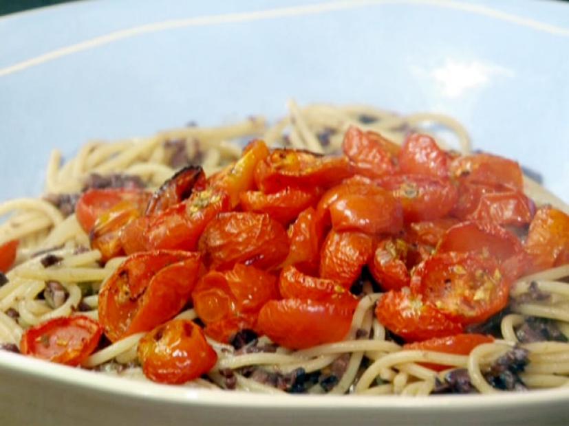 Spaghetti with tapenade sauce and roasted cherry tomatoes are served with anchovies, capers, and Kalamata olives.