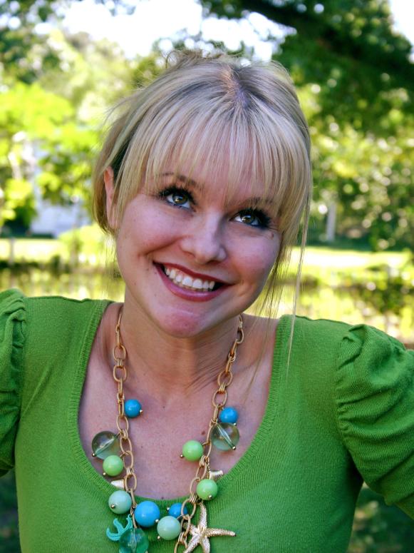A close-up of Next Food Network Star contestant Jen Isham smiling while wearing a green blouse
