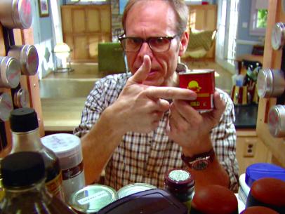 Alton Brown selects his spices from the pantry.