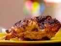 A piece of grilled chicken was marinated in dijon with meyer lemon juice.