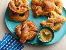 For a taste of the fair at home, try Alton Brown's Homemade Soft Pretzels recipe from Good Eats on Food Network.