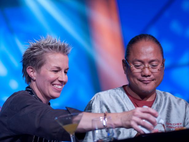 Rival-Chef Elizabeth Falkner serving Guest Judge Iron Chef Masaharu Morimoto at Judges Table in Episode 8 Finale Battle "Holiday Extravaganza" as seen on Food Network Next Iron Chef Season 4.