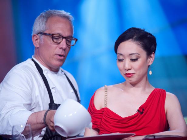 Rival-Chef Geoffrey Zakarian serving Judge Judy Joo at Judges Table in Episode 8 Finale Battle "Holiday Extravaganza" as seen on Food Network Next Iron Chef Season 4.