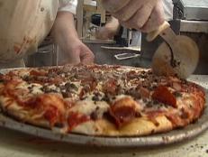 <p>A drive-in pizzeria that also sells onion rings and salads is a rather odd combination, but the Pizza Palace has been a Knoxville, Tenn., staple for decades. Their spaghetti is served with a homemade meat sauce, created by owners Sam and Charlie Peroulas, that almost left Guy speechless.</p>