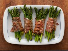 Rachael Ray's Bacon-Wrapped Asparagus Bundles recipe, from 30 Minute Meals on Food Network, can be easily prepared on an outdoor grill or in a hot oven.