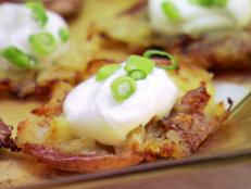 Claire Robinson's smashed potatoes are loaded with sour cream and scallions. Get the recipe from Food Network.