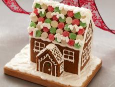 Follow Food Network's simple recipe and easy-to-follow tips for making a show-stopping gingerbread house from scratch.