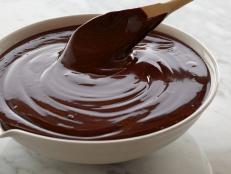 Alton Brown's recipe for two-ingredient chocolate Ganache Frosting from Food Network is decadent yet easy and the perfect topping to cakes, cupcakes and more.