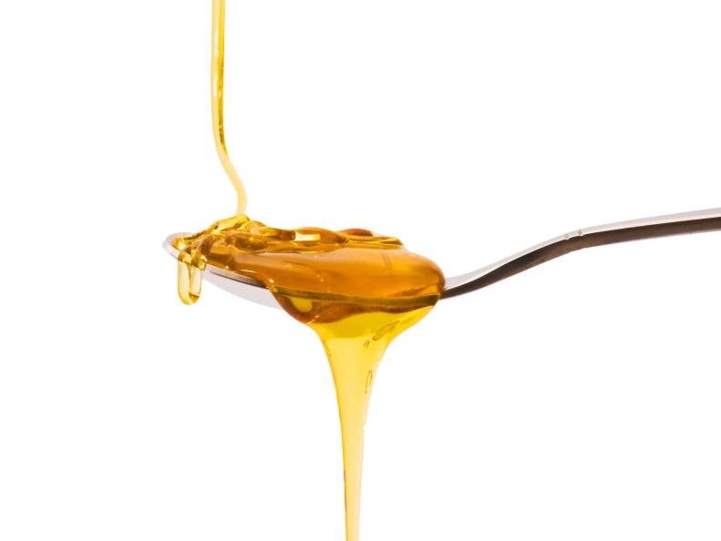liquid honey and a spoon