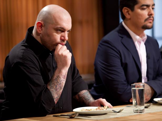 Chris Santos and Aaron Sanchez taste dishes and judge as seen on Food Network’s Chopped, Season 13.