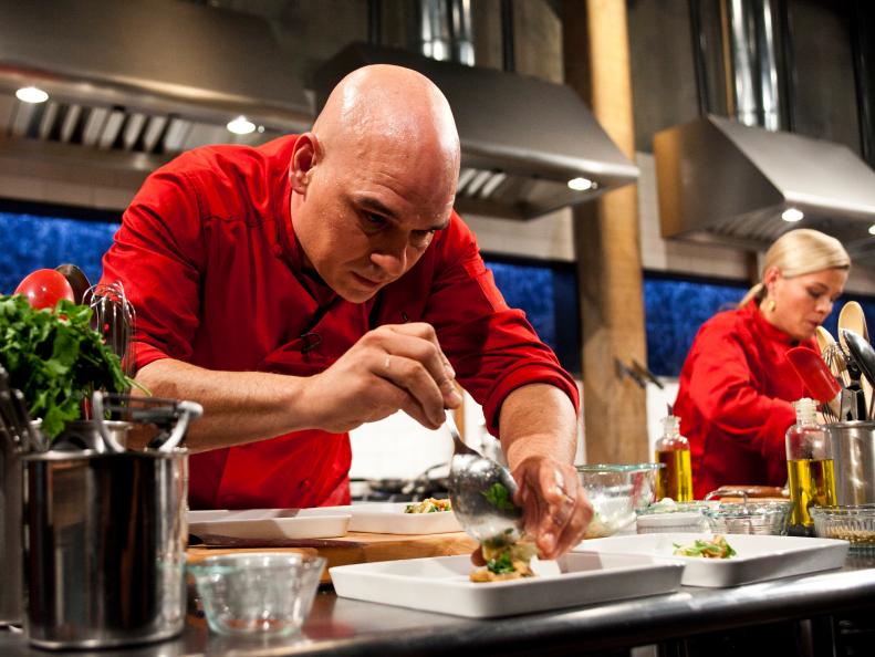 Iron Chef Cat Cora and Iron Chef Michael Symon working on their appetizers as seen on Food Networks, Chopped All Stars Tournament, Season 10 EP10-09