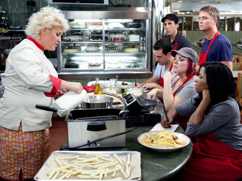Chef Anne Burrell at the Tick-Tock Diner teaching her Red Team (f-b) Kelli Powers, Dorothy Strouhal, David Shelton, Anthony Schiano and Sean Bennett ,how to approach their challenge of Late Night Fries with her recipe for Poutine with Ham, Fontina Cheese Sauce, Sunny Side Up Egg, as seen on Food Network’s Worst Cooks in America, Season 3.