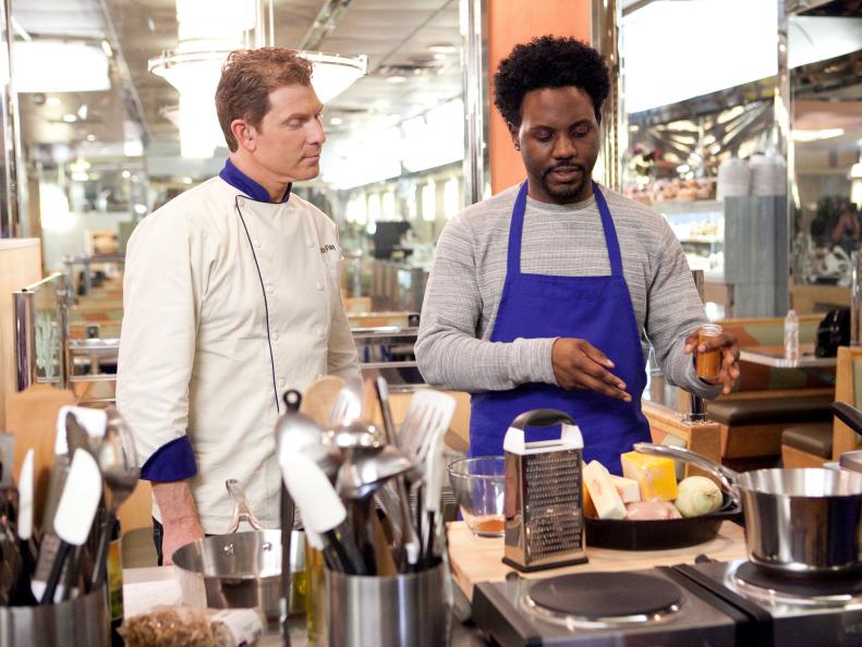 Benjamin Dennis  of the Blue Team explains to Chef Bobby Flay about his Spicy Chicken Nachos with Mango Orange Pico at the Tick-Tock Diner , as seen on Food Network’s Worst Cooks in America, Season 3.