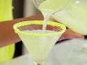 A lemon meringue martini is poured.
