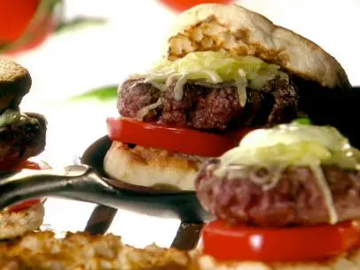 A close up of Melissa d'Arabian's perfect basil burgers on a toasted english muffin with fresh tomato, mozzarella, and a creamy basil sauce.