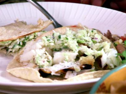 A plate of southern fish tacos is served.