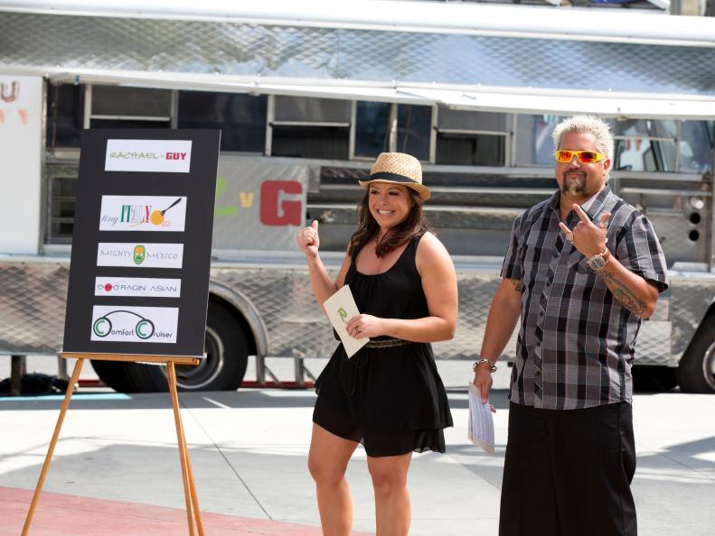 Host/Team Leaders Rachael Ray and Guy Fieri telling the contestants about the "Lunch Trucks" Challenge, as seen on Food Network’s Rachael vs. Guy, Celebrity Cook-Off, Season 2.
