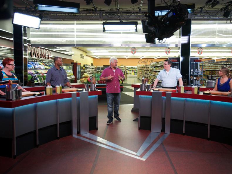 Host Guy Fieri with the chefs Karen Forsberg, Stanley Hagerman, Tom Ramsey, and Nia Pullinzi, during the introduction of Game 1, Out of Stock, Spaghetti and Meatballs, as seen on Food Network's Guy's Grocery Games, Season 1.