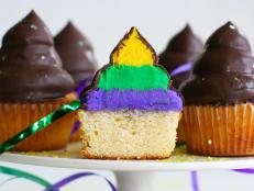 With Mardi Gras around the corner, I thought I'd bake up something the whole family can enjoy. There is something so appealing about a hi-hat cupcake. You can't go wrong with a delectable yellow cupcake covered in sweet clouds of hi-hat frosting and gently dipped in chocolate.