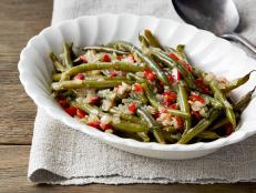 Ree Drummond's Best Green Beans Ever recipe, from The Pioneer Woman on Food Network, starts with bacon grease and gains even more flavor from chicken stock.