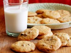 Bring a taste of fall to a dessert favorite by baking Food Network's Pumpkin Chocolate Chip Cookies recipe with canned pumpkin puree and spices.