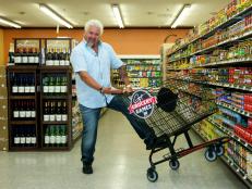 Host Guy Fieri poses with a grocery cart during the taping of Food Network's Guy's Grocery Games, Season 1.