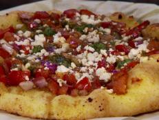 <p>The thin cornmeal crust sprinkled with sesame seeds is the secret to all the pies at this pizzeria. Guy, a meat lover, devoured the Texan pizza topped with sausage, green chiles, pepperoni and Canadian bacon. The homemade pesto and balsamic vinegar sent Penny's Bruschetta over the edge.</p>